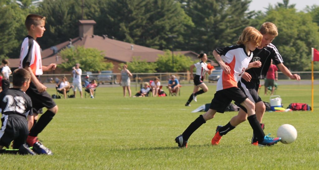 Jugendliche die Fussballspielen ist ein Beispiel von Teamarbeit